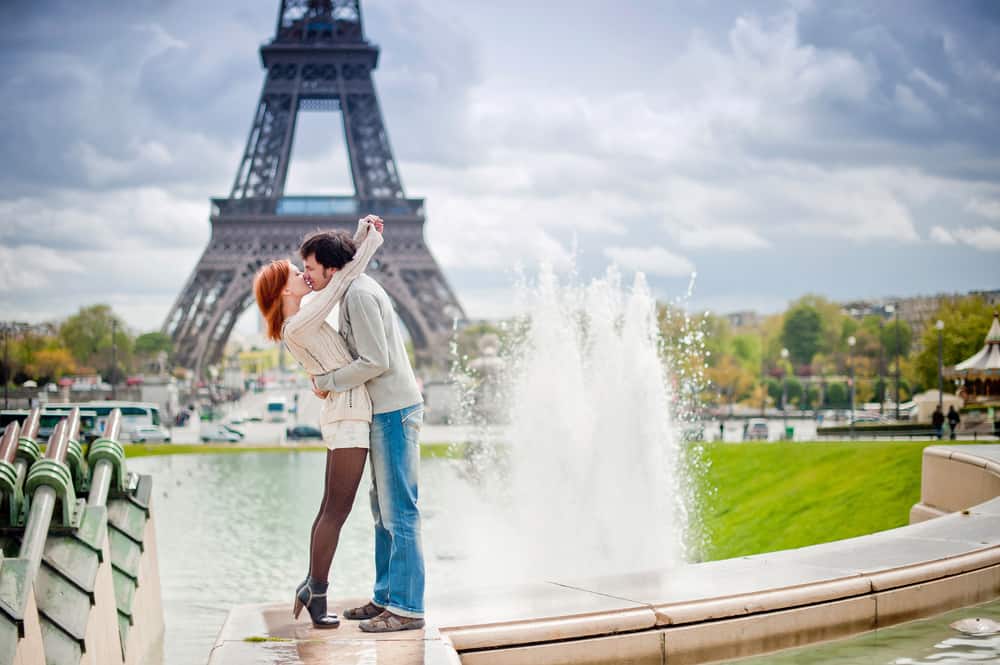 couple kissing on their honeymoon in Paris at the Trocadero