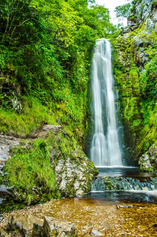 Waterfall in Ireland surrounded by greenery