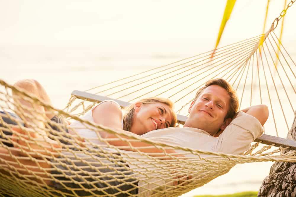 Photo of couple in hammock who may be enjoying a honeymoon in Hawaii.