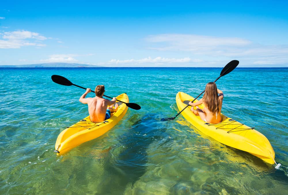 Photo of couple kayaking, an excellent Hawaii Honeymoon activity.