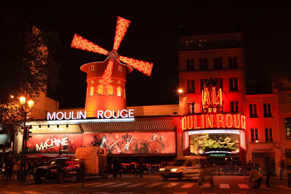 The Moulin Rouge is illuminated red at night
