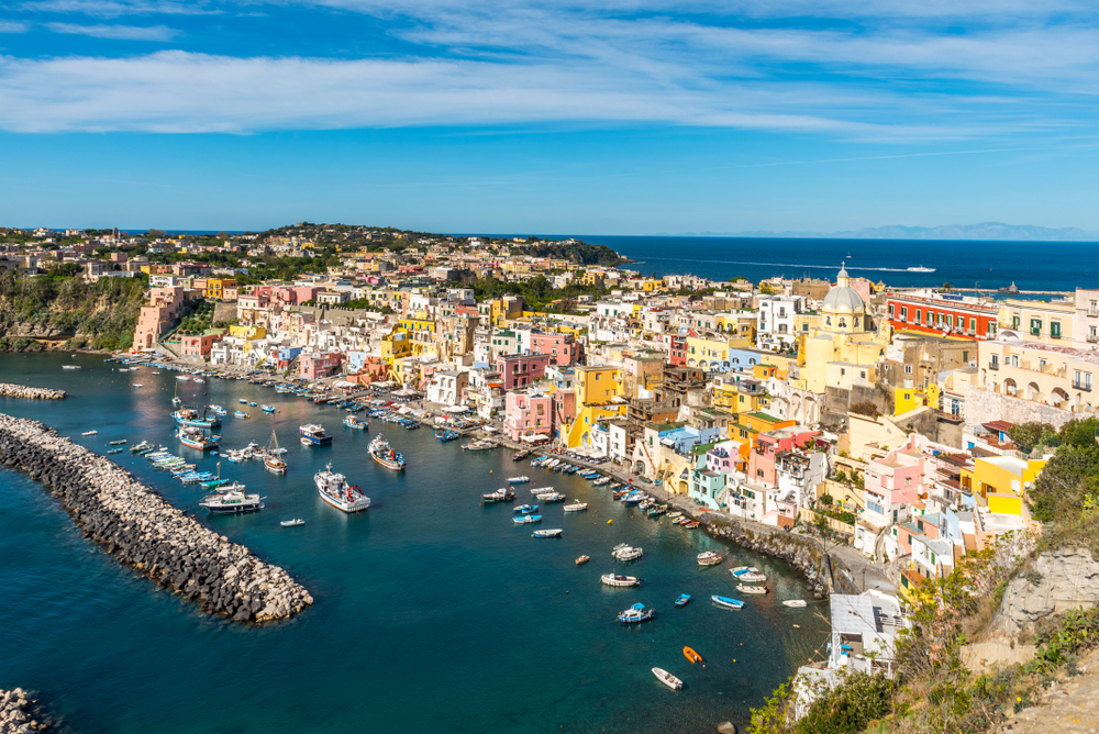 Corricella a small town in italy with colorful buildings on the seaside and boats in the water