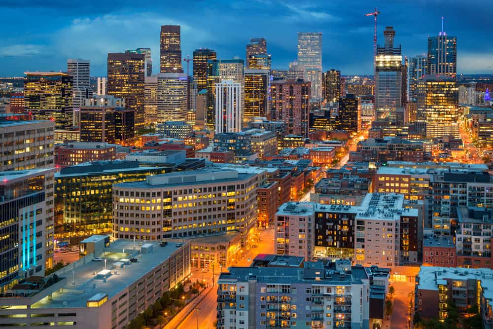 Downtown Denver lit up at dusk.