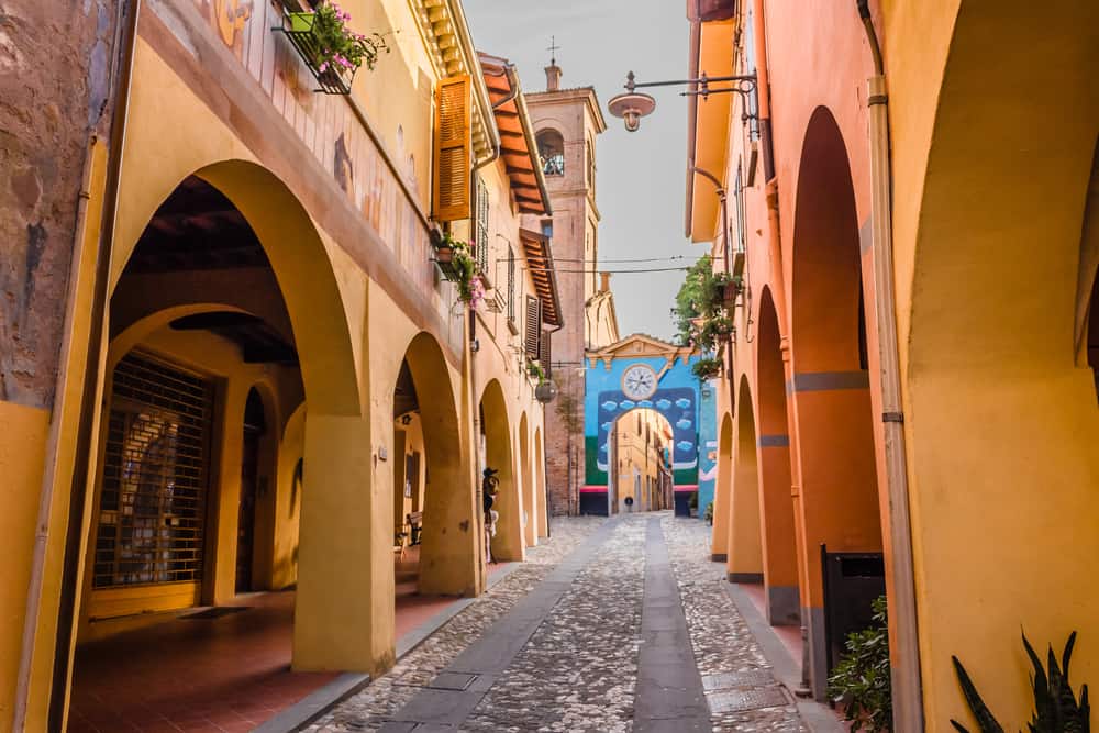 small town in italy with painted yellow walls