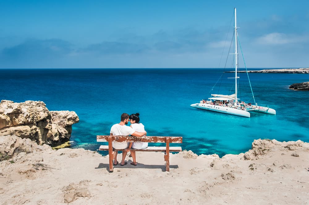 Photo of couple by the water.