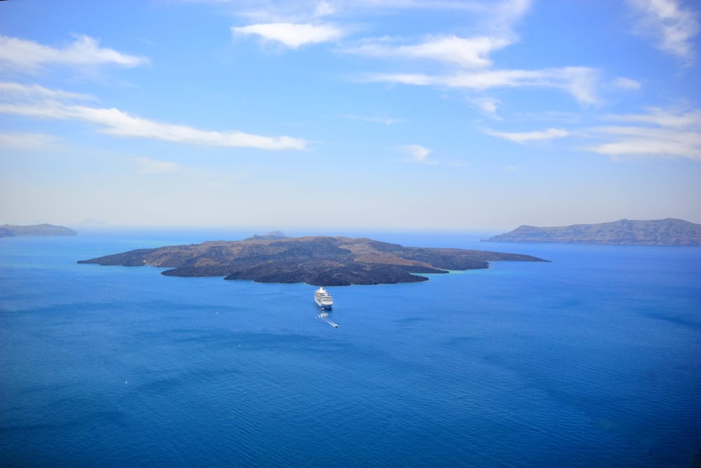 Photo of island formed by volcano you could visit during your Greece honeymoon.
