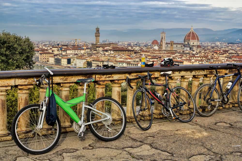 bicycles sitting against a fence looking out onto Florence 