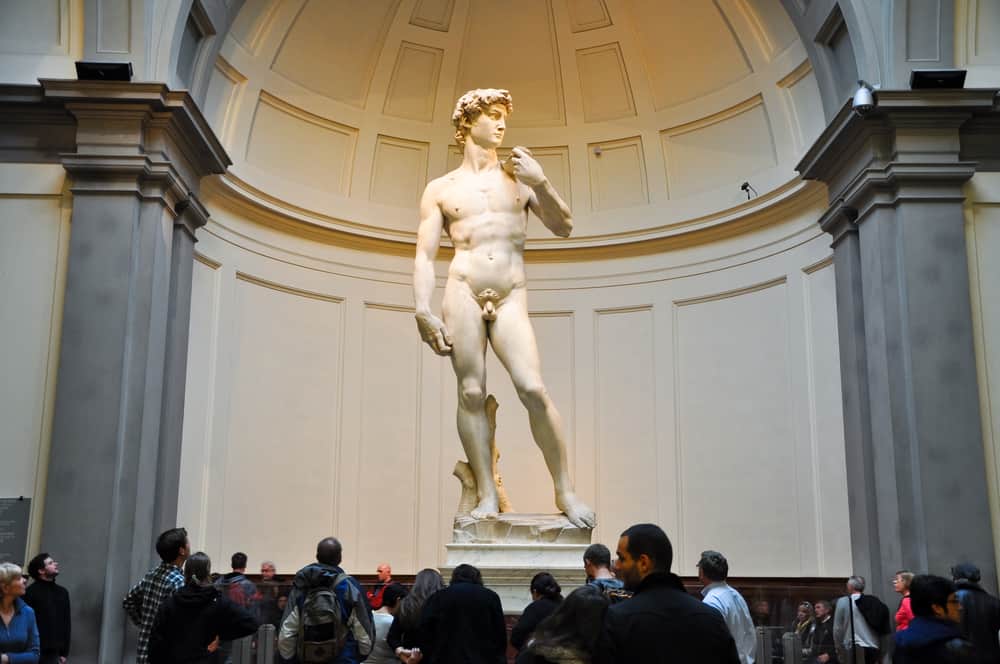 group of people viewing statue of david