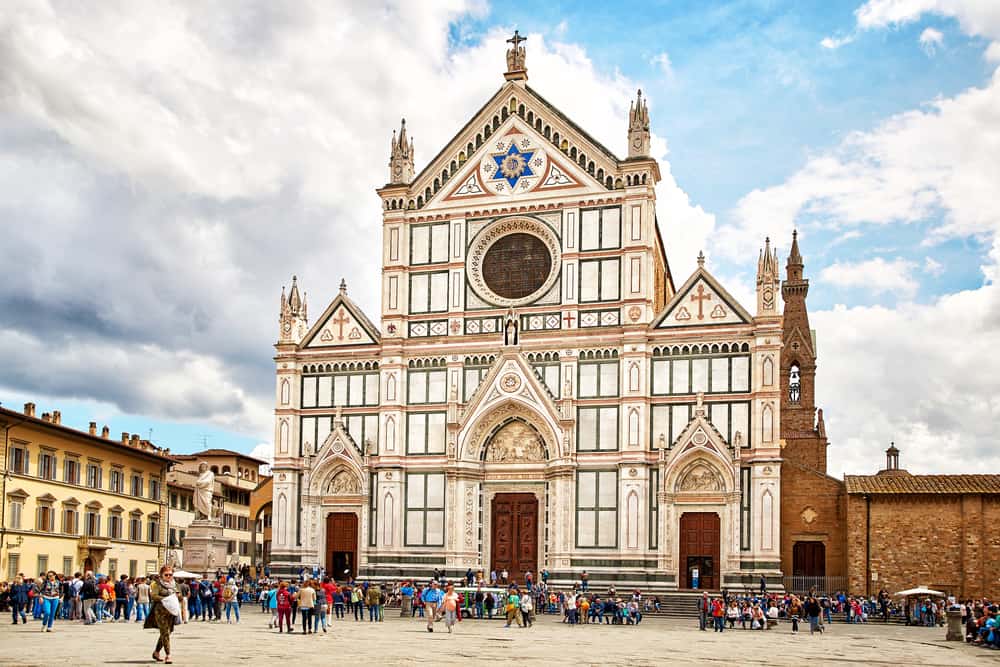 the basilica of santa croce during a busy sunny day