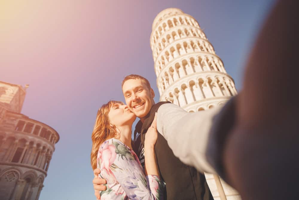 Photo of couple in Pisa, looking almost as happy as you will during your own Tuscany honeymoon.