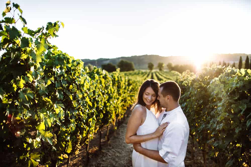 Photo of couple in a vineyard in Tuscany.