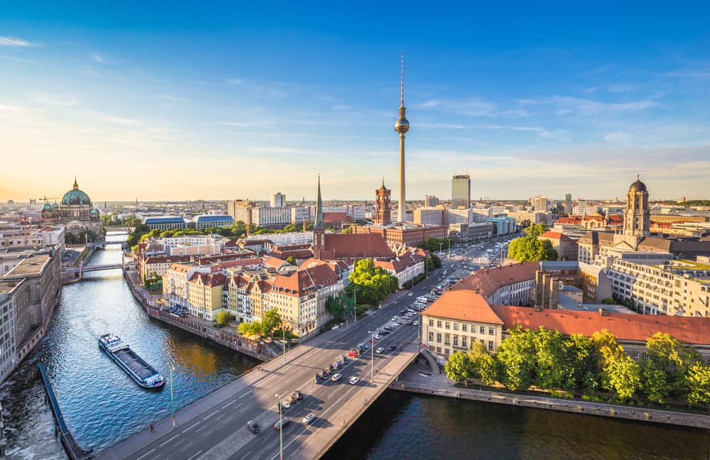 Aerial view of Berlin skyline and Spree River during golden hour.