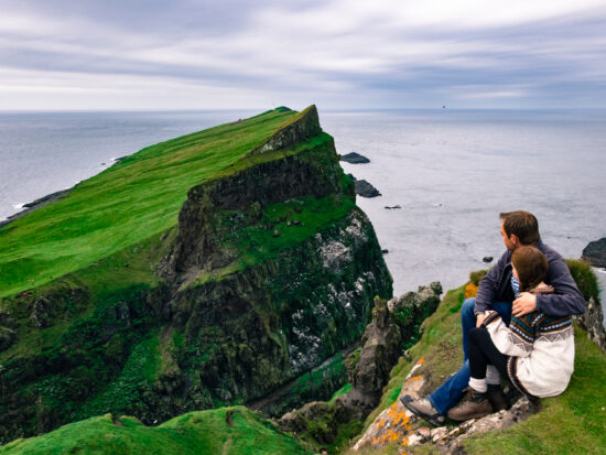 Photo of a couple overlooking cliffs in Ireland.