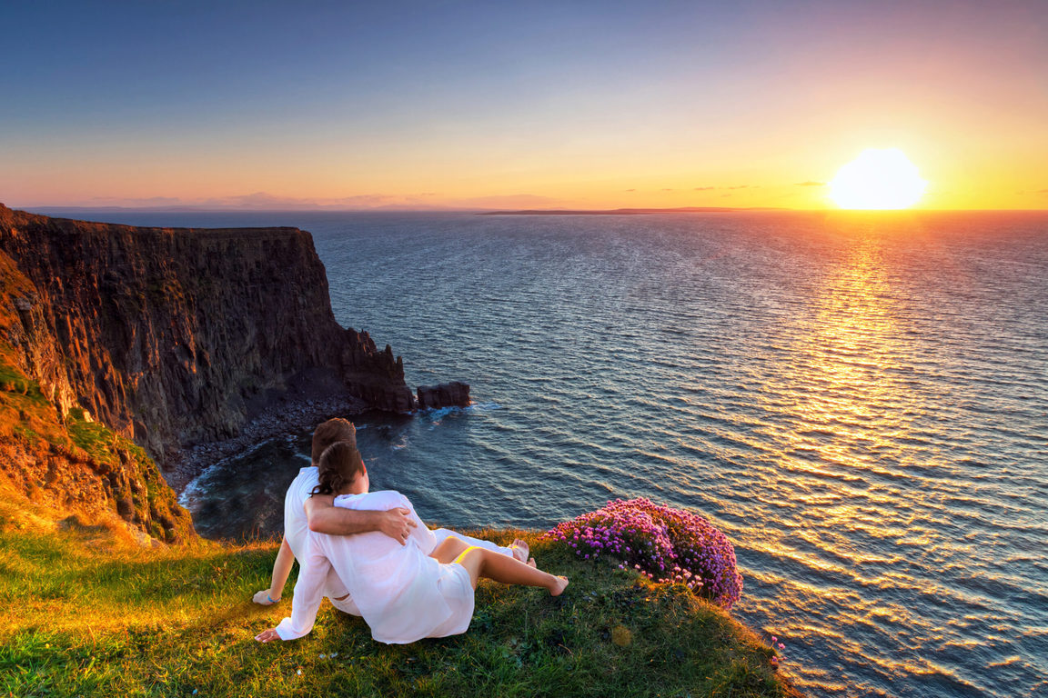 Photo of a couple on a cliff-side.