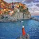 woman in red dress standing in Manarola one of the smaller cities in italy on the riviera