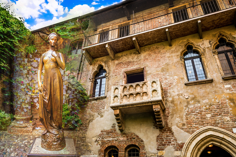 Juliet's balcony with a statue of Juliet next to it.