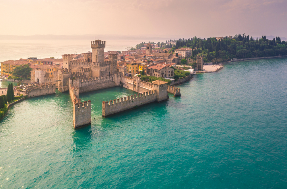 aerial view of Scagliero Castle on the water Northern Italy itinerary