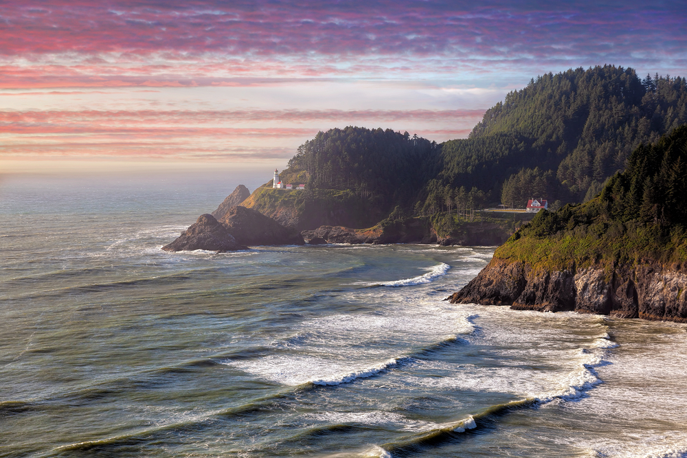 distant view of the Heceta Head Lighthouse on your Oregon coast road trip