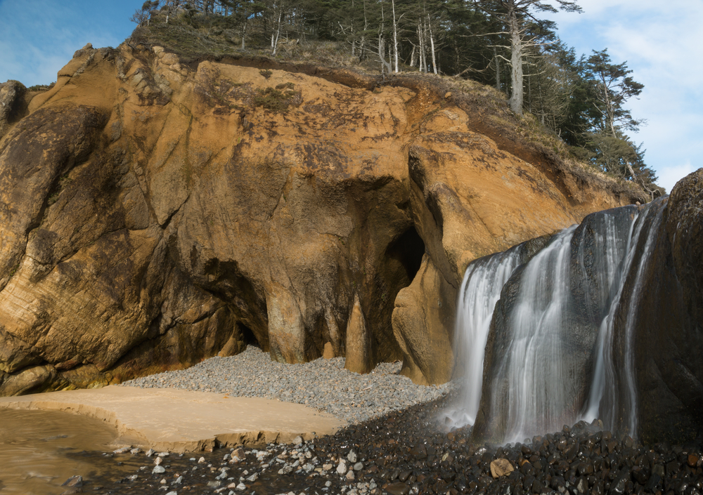 the Hug Point waterfall on your Oregon coast road trip