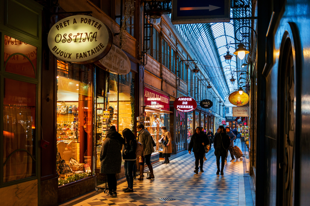 People window shopping in a covered passage in Paris.