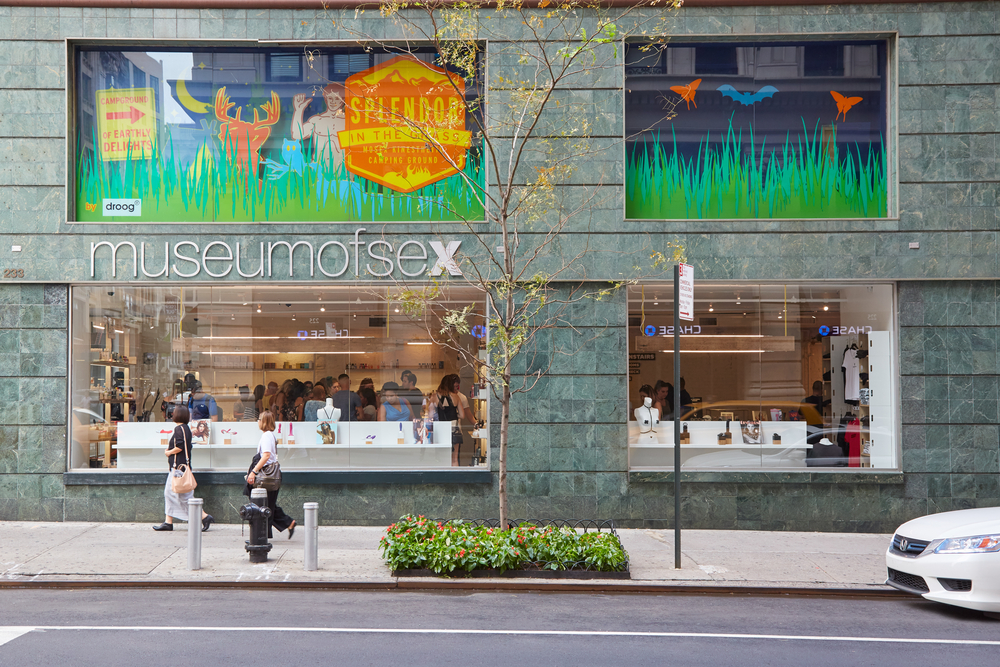 People walk by the front of the museum of sex