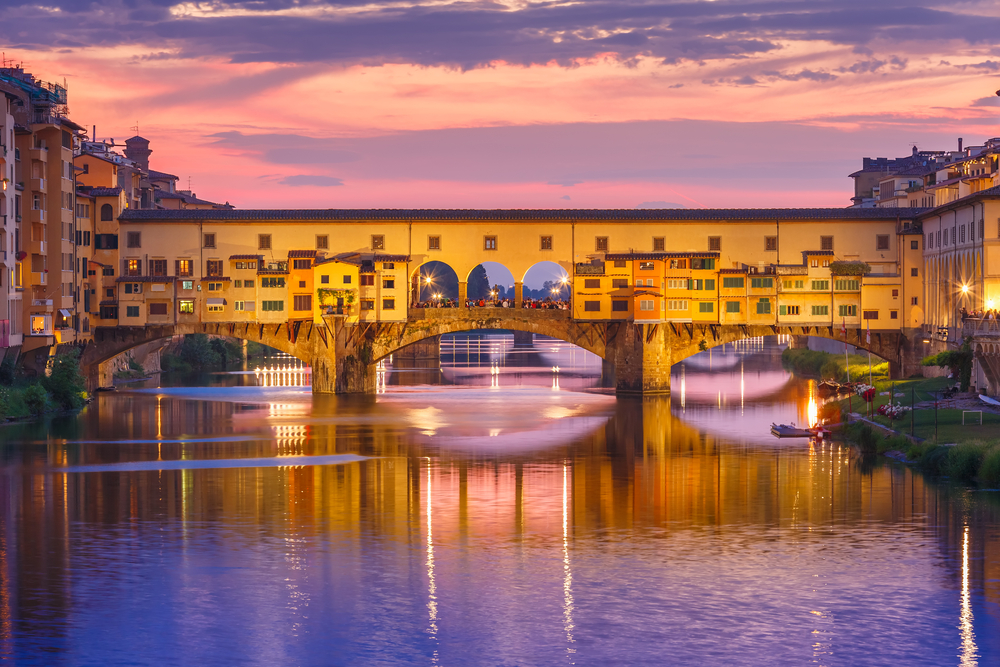 Purple and pink sunset over Ponte Vecchio and the river.