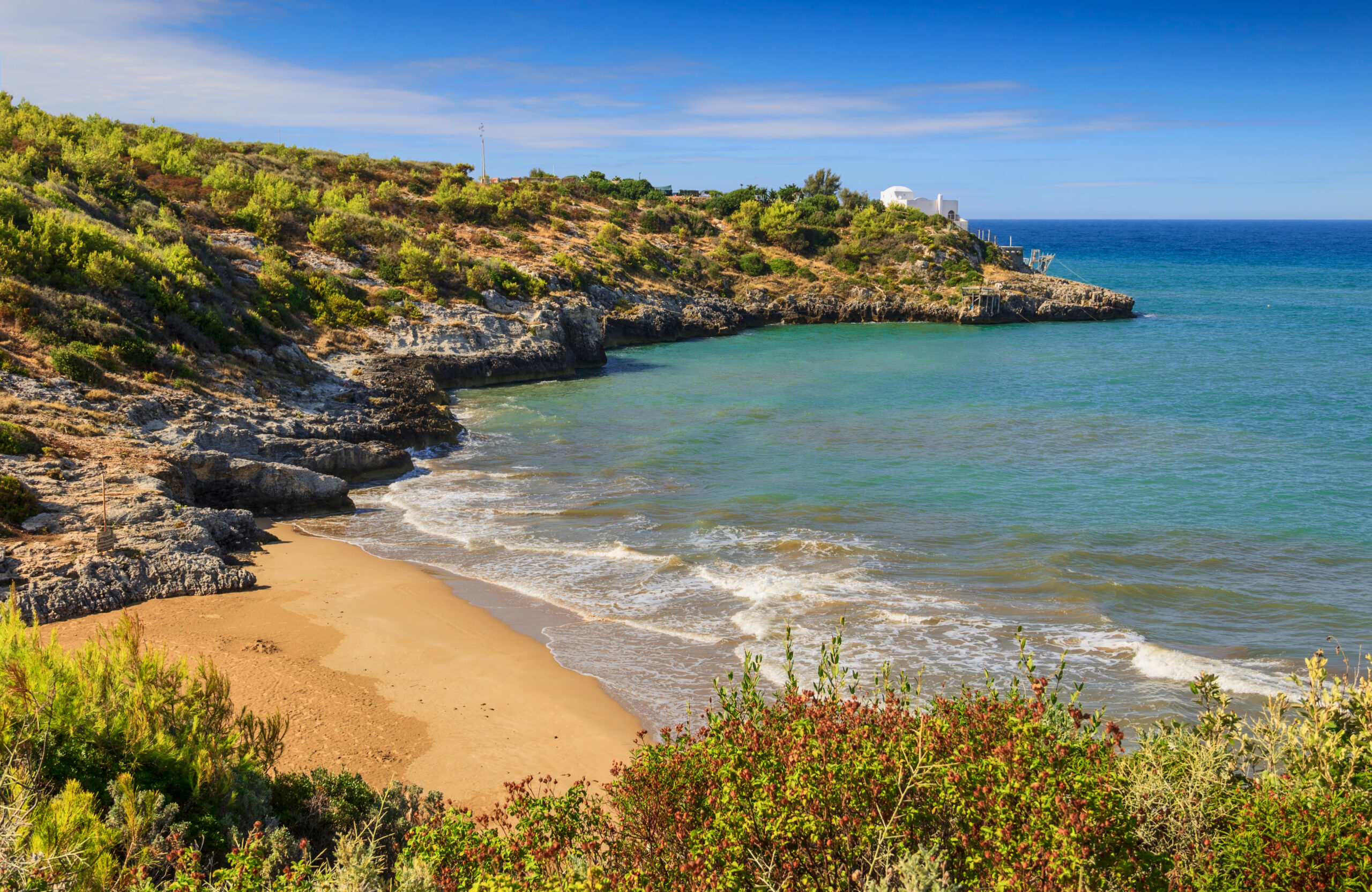 Photo of Santa Croce beach, one of the more secluded Amalfi Coast beaches. A rugged coastline with sparkling light blue water. 