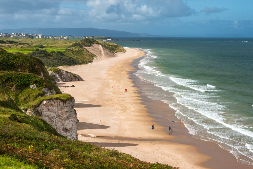 The dazzling beach lined by limestone cliffs at Portrush Whiterocks Beach in Ireland