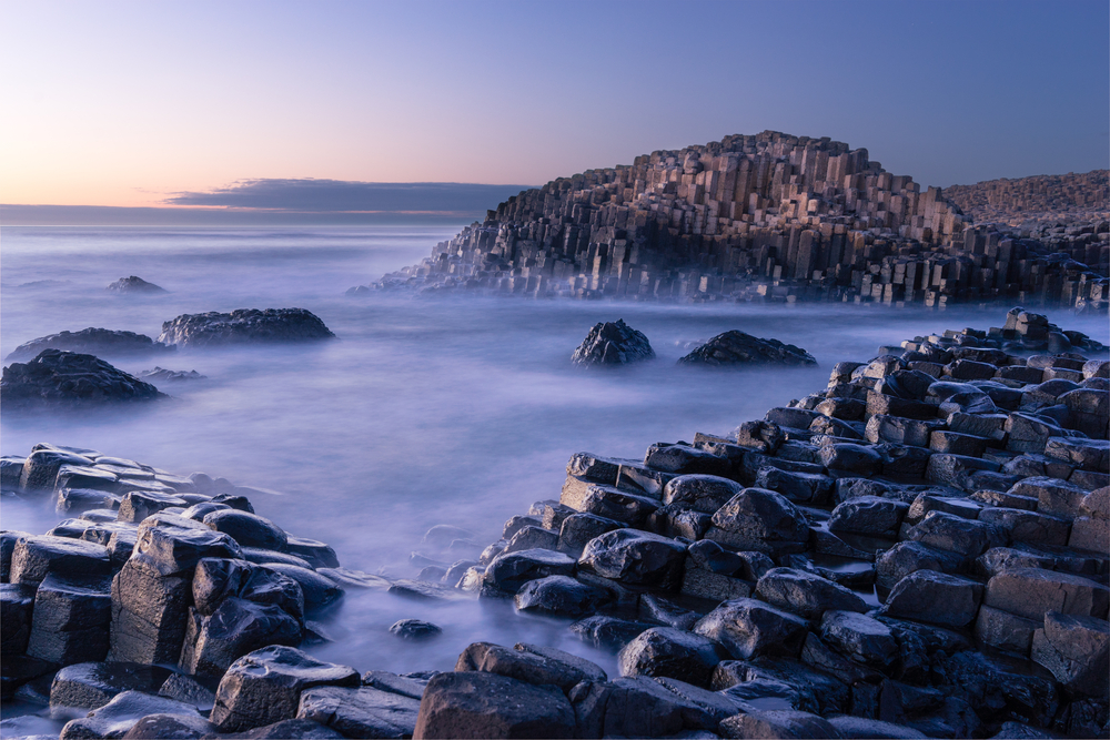 foggy landscape filled with hexagonal rocks giants causeway day trips from Dublin