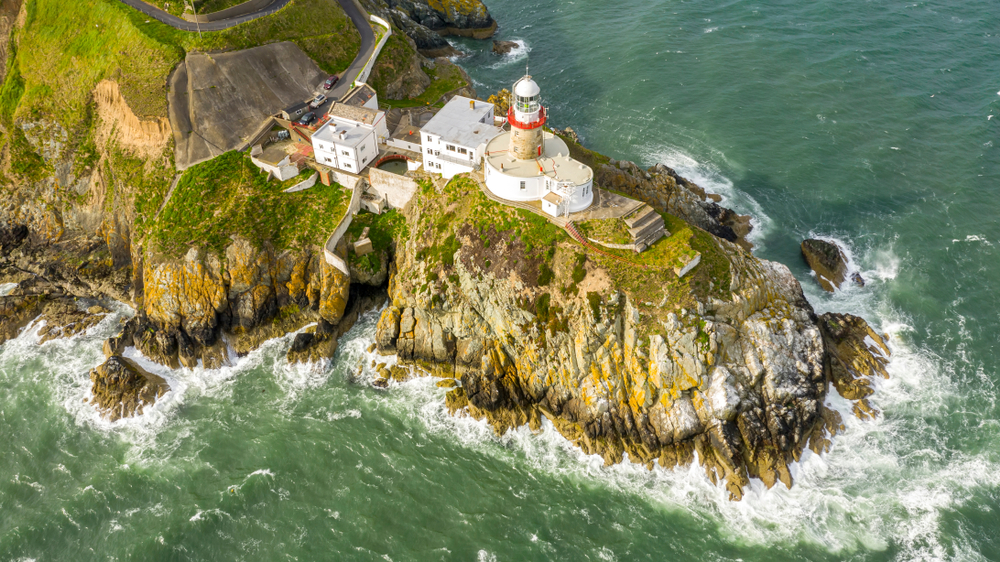aerial view of Howth lighthouse on green cliff
