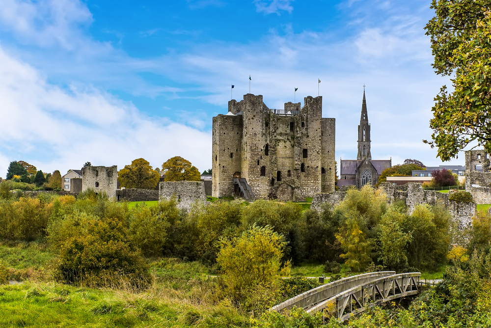 towering historic castle surrounded by greenery