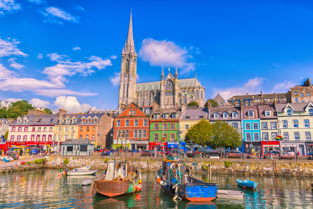 Fishing boats inside the port. A city with colorful houses in Ireland.