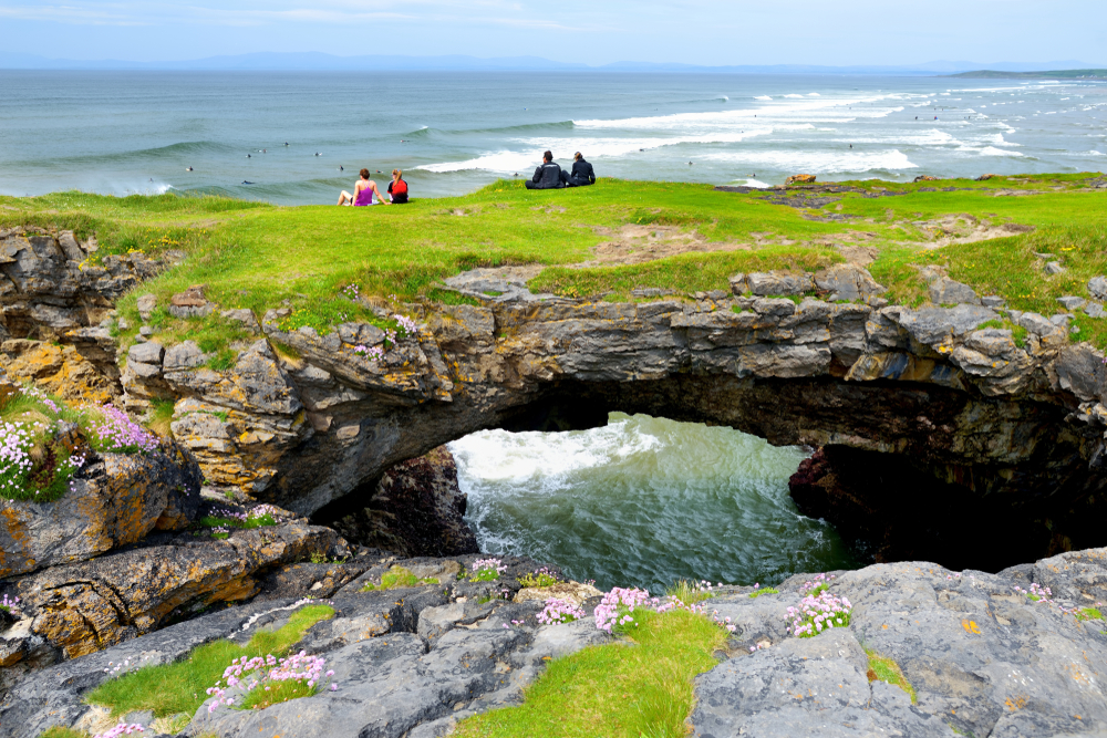 Sitting on a natural bridge looking out over the ocean is one of the best things to do in Donegal.