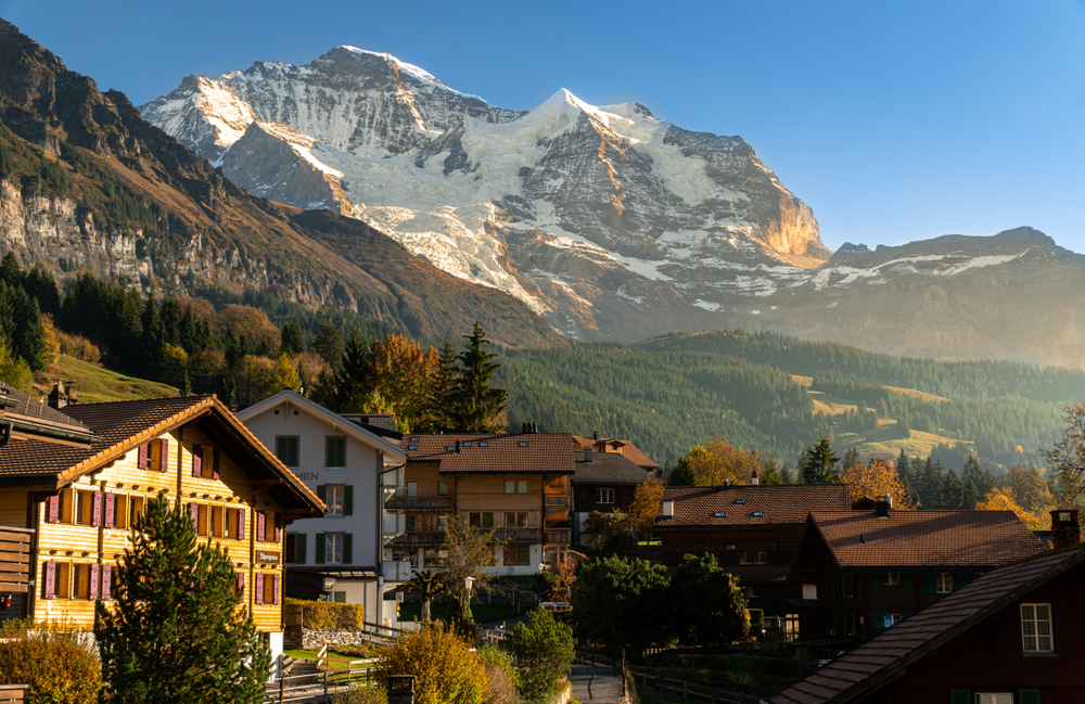 A beautiful small town in Switzerland typical Swiss chalets and a mountain backdrop 