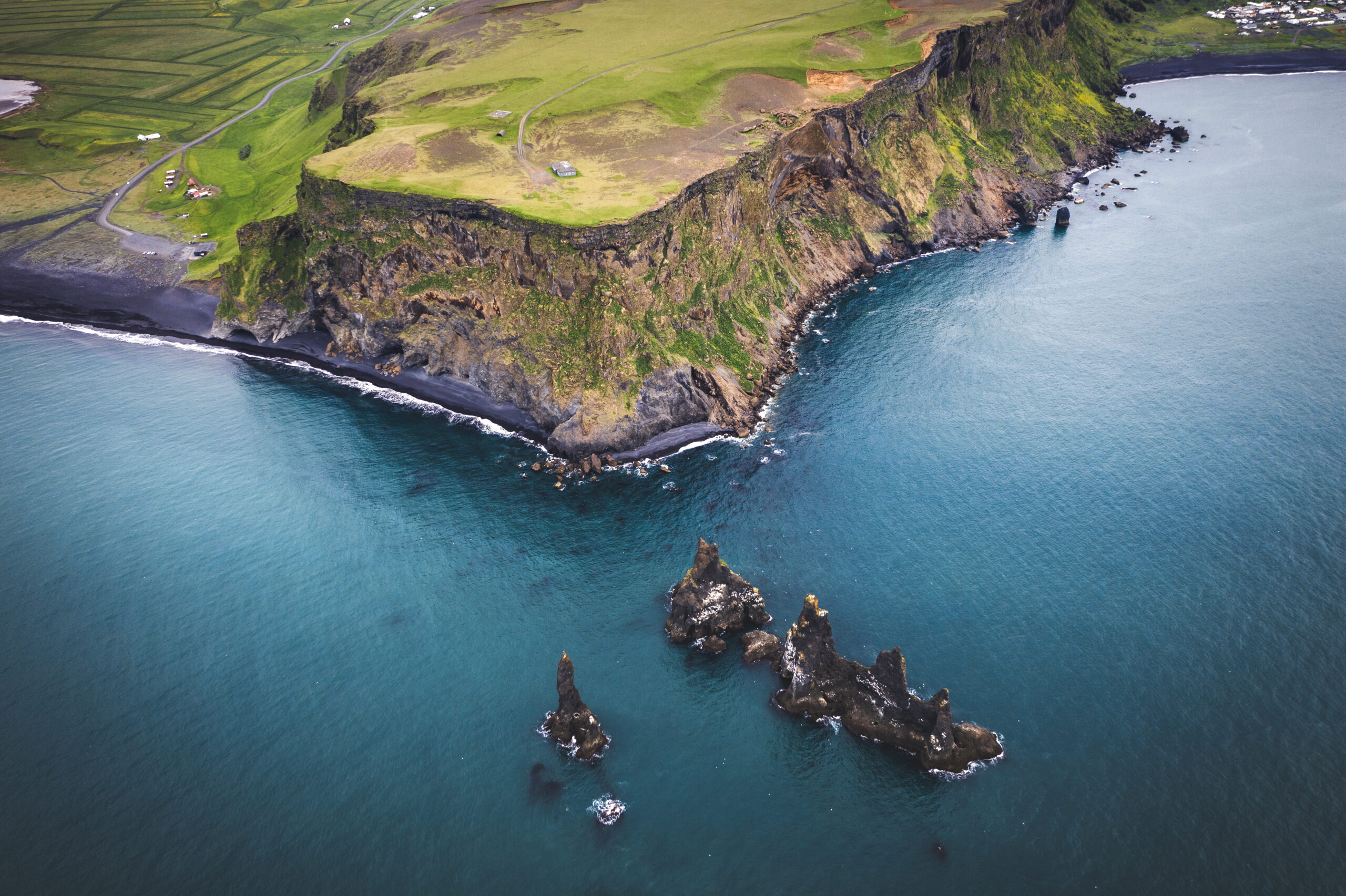 Iceland, Dyrholaey cape. Aerial landscape photo by drone. Amazing volcanic terrain of Iceland from above. Dyrholaey is spot of Golden Circle touristic path in Iceland. Black sand beach nearby Vik.