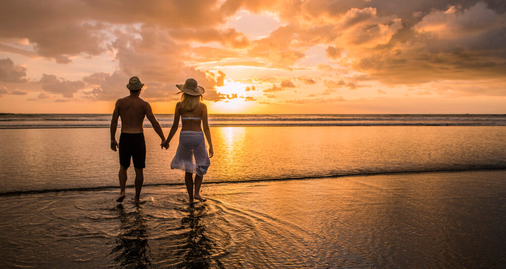 couple enjoying sunset on the beach on their costa rica honeymoon