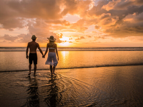 couple enjoying sunset on the beach on their costa rica honeymoon