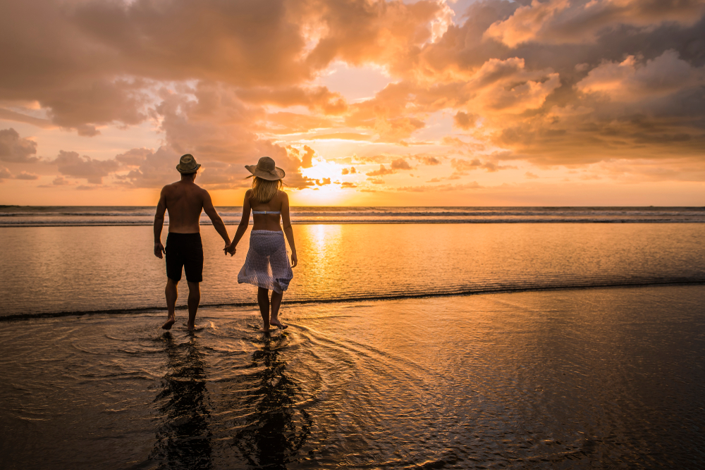 couple enjoying sunset on the beach on their costa rica honeymoon
