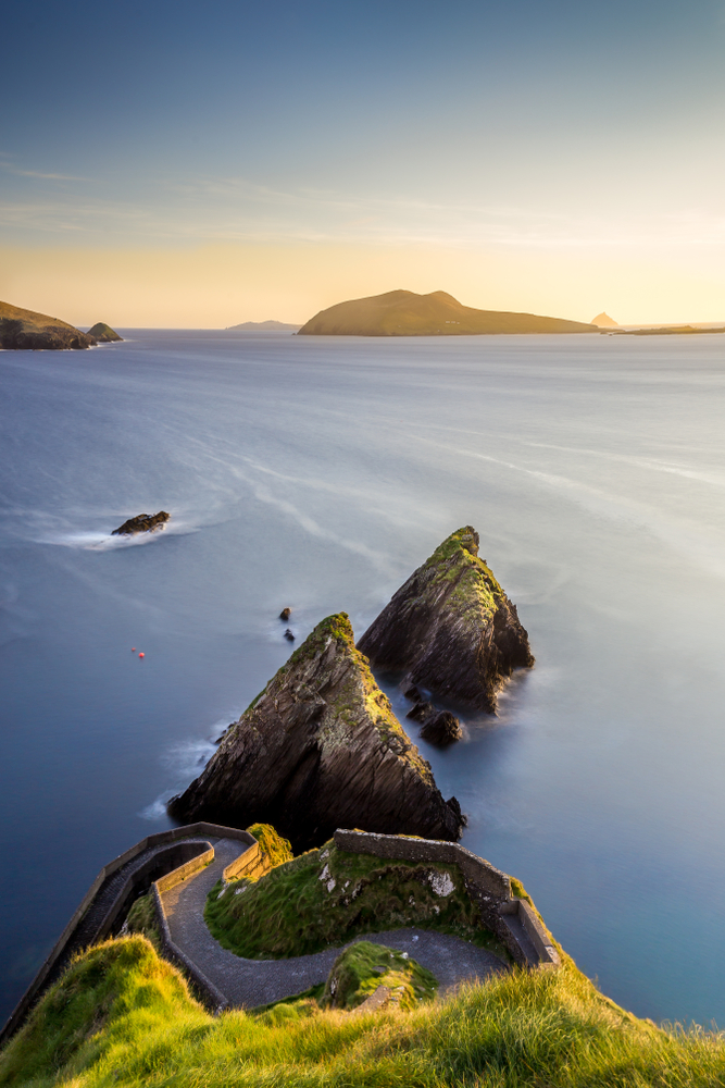 The cliffs and Dunquin Harbor at sunset with a view of the Blasket Islands