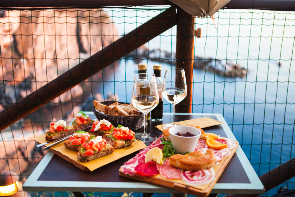 photo of the antipasto in Manarola with a bottle of wine on the table. 