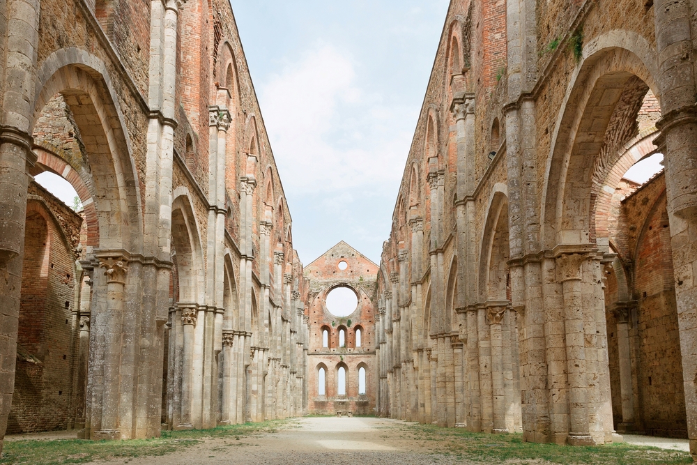 crumbling red-colored brick walls of San Galgano Abbey