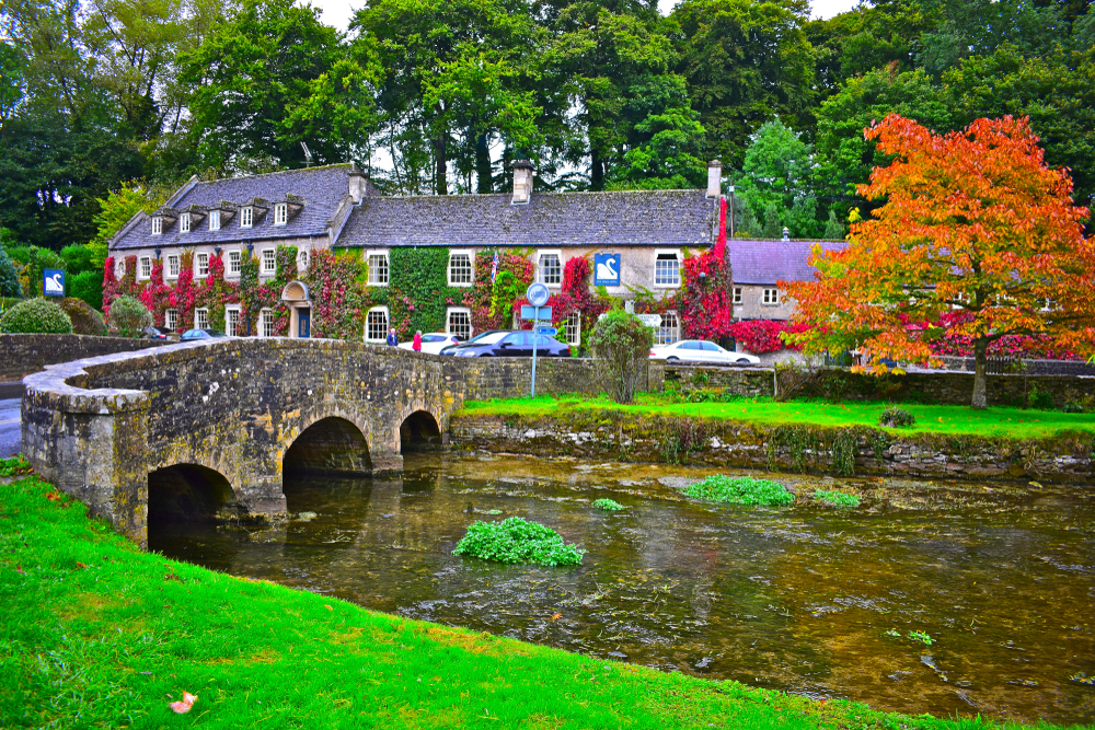 photo overlooking a river in the town of bibury, southern england
