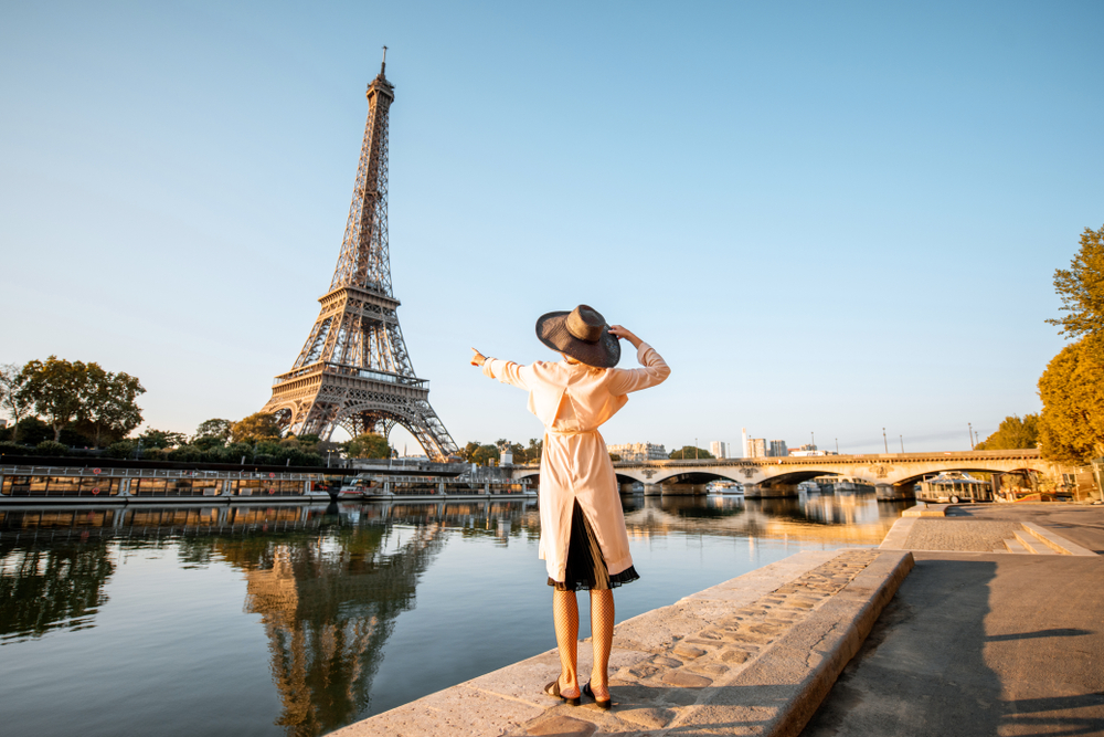 Photo of woman looking at the Eiffel Tower