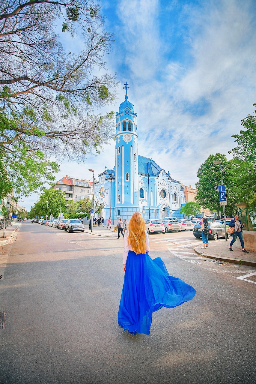 Hidden Gems in Europe Church of St. Elizabeth with girl in blue dress in fornt.
