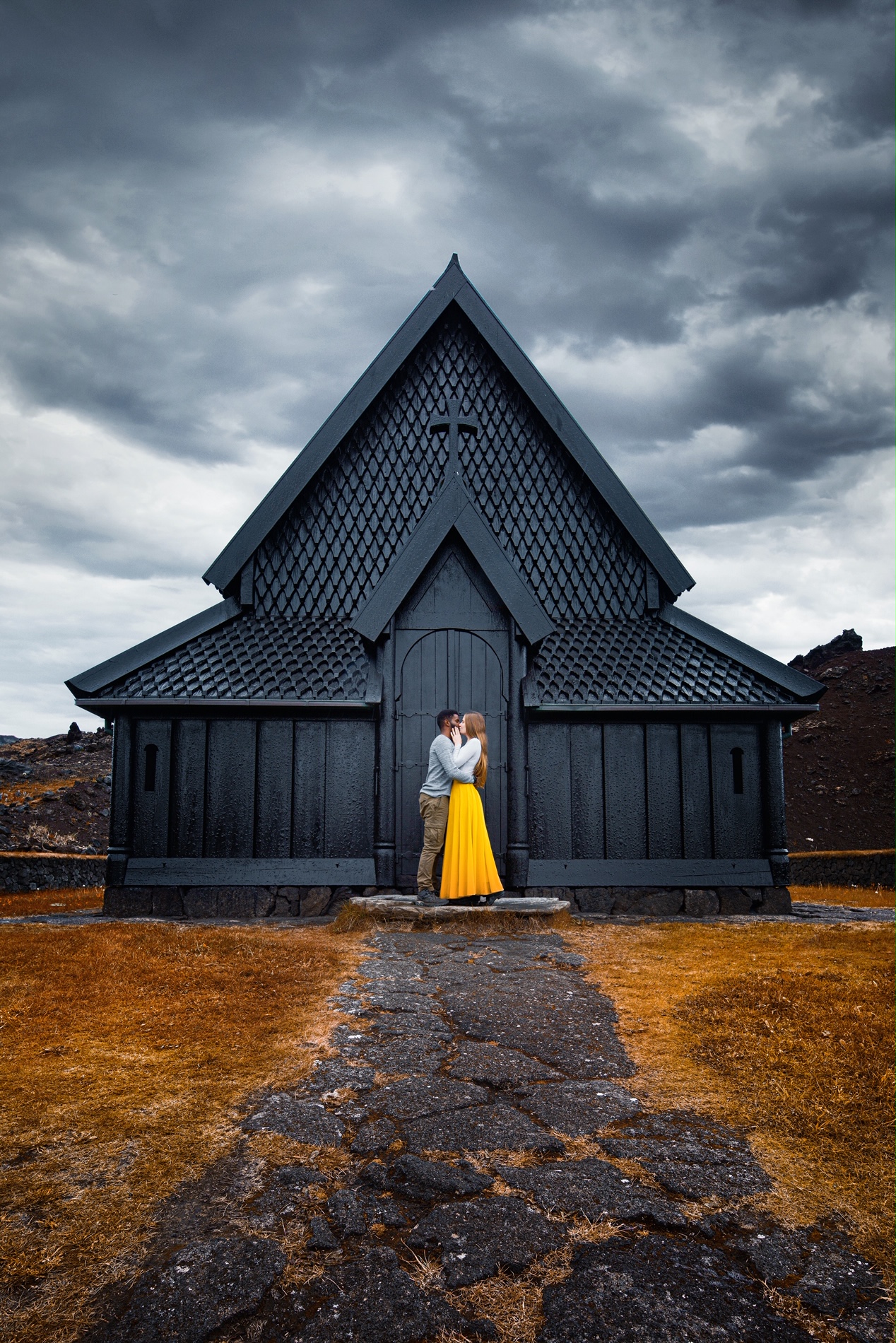 Hidden Gems in Europe Heimaey Stave Church with young couple in front