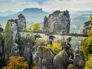 Bastei Bridge seems to float among the rock spires high above the trees.