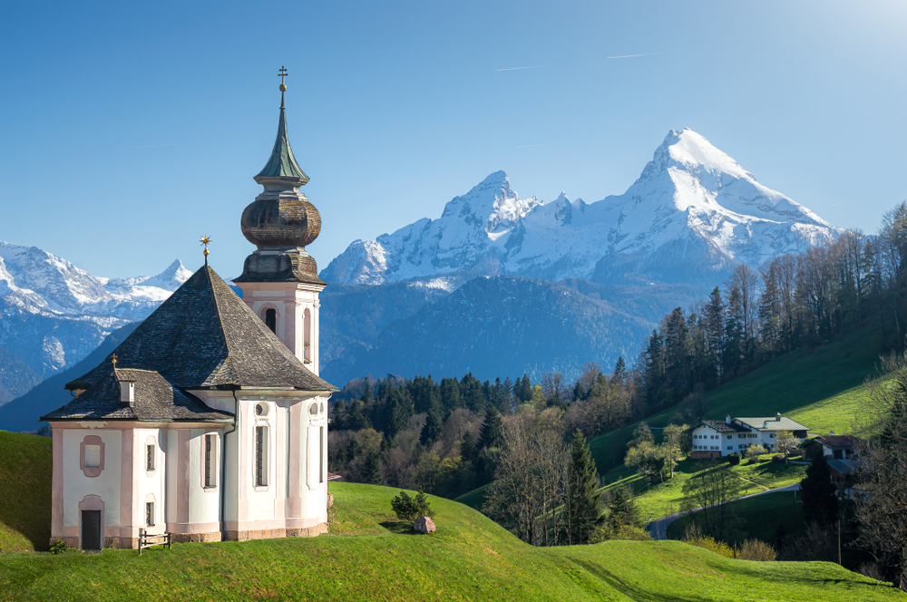 Pilgrimage Church Maria Gern, one of the most gorgeous hidden gems in Germany with snow capped mountains in the distance.