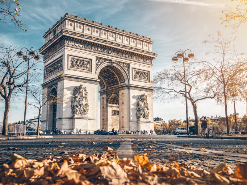 Fall at the Arc De Triomphe. A low shot of the monument with leaves on the ground in front. 