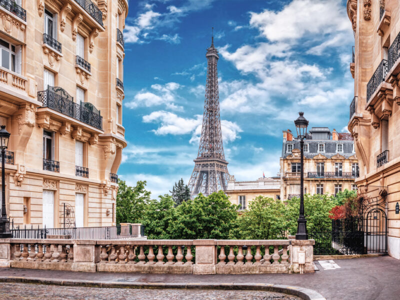 A unique view of the Eiffel Tower in Paris from between two picturesque buildings. 