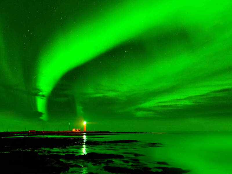 A look at The Northern Lights, shining green over the Grotta Lighthouse at night. 